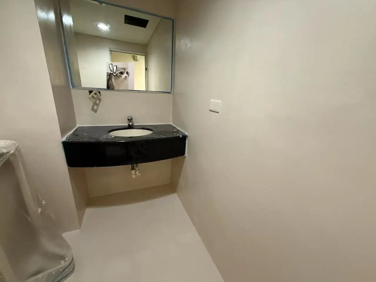 Completed vanity area with continuous wall and floor finish.